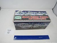 Full view of the boxed Hess 2004 Sport Utility Vehicle and Motorcycles toy set with packaging showing brand and item details.