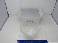Front view of clear Marquis Waterford crystal bowl with intricate cut patterns, placed in front of the original Marquis box and lot identification card.