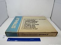 Closed cardboard box with 'STAHLS' brand and various font options listed on the top for Letter-Perfect letters set.