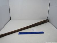 Full length of the vintage wooden baseball bat shown alongside a blue ruler for size reference.