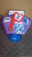 Front and side view showing Blue's Clues graphic, purple mailbox body, red flag, and 'Try Me' button.