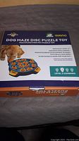 Photo of box top showing dog puzzle toy packaging and description