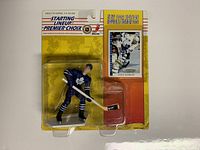 Front view of the Doug Gilmour 1994 Kenner Starting Lineup figure still in original yellow and orange packaging with collectible card beside figure.