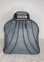 Gray bowling ball carrying case with black trim and handle, shown from the front