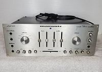 Front view of Marantz Model 1120 amplifier showing aluminum faceplate, knobs, sliders and cosmetic wear