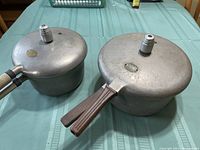 Top view of both pressure cooker lids with handles showing Presto badges on the lids.