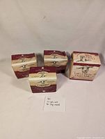 Four sealed boxes of Caprina goat's milk soap bars arranged with a handwritten note describing the lot content.