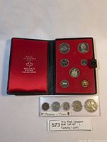 1972 Royal Canadian Mint coin set opened in black leather case with red interior and Panama coin set in plastic holder beneath.