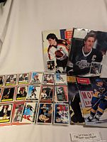 Display of hockey cards laid out in protective sleeves alongside Beckett Hockey Monthly magazines.