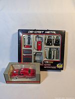 Photo of the red 1949 Ford Street Rod diecast car model in Snap On packaging next to WT Garage 10-piece diecast metal garage accessory set in original packaging.