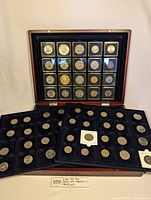 Full display of three trays holding 60 coins in total inside a Leuchtturm mahogany case, showing the layout and quantity.
