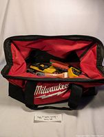 Open Milwaukee tool bag showing various tools inside