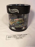 Front view of the Limited Edition Hot Wheels Snake & Mongoose "Snake Rocket Oil" diecast car inside clear display case with tire-textured black lid and branding.