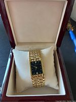 Watch displayed on pillow inside wood presentation case