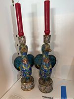 Front view of two bird-form cloisonné candlesticks
