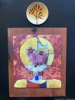 Overview of small copper dish above and copper plate mounted on wooden plaque below