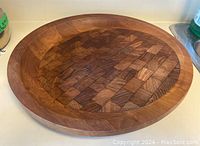 Top angled view showing the circular edge-grain and end-grain block pattern with a slightly concave surface and rich wood tones.