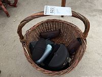 Wicker basket containing assorted eyeglass and sunglass cases