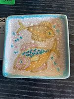 Top view showing square dish with fish motifs
