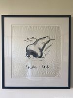 Framed silk scarf lithograph hanging on wall showing full artwork and frame