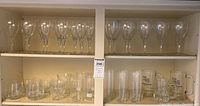 Two shelves with various stemware and tumblers, clear glass, large glasses approx. 10 inches tall