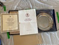 Certificate of authenticity, presentation booklet and plate in original box