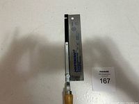 Full view of the hand saw showing wooden handle, metal frame, and saw blade on white background with lot card.