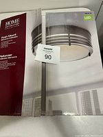 Photo of the original box showing the brand, model, and style of the flush mount ceiling light.