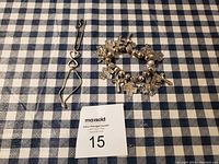 Overview photo of the three custom bracelets including two silver-tone charm bracelets with cross motifs and one wire bracelet with a heart detail.