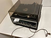 Full view of the Zenith vintage record player and amplifier with dust cover in closed position.