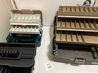 Two toolboxes with white removable trays and a gray fish box organizer showing compartments and trays