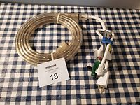 Photo of coiled transparent LED strip light with attached power cord and plug.