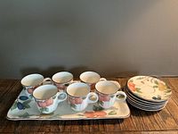 Full view of set including 6 espresso cups, 6 matching saucers, and serving tray showing fruit design and layout.