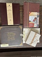 5 albums laid out on wood table, showing variety of covers and sizes