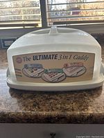 Closed Wilton Ultimate 3 in 1 Cupcake Caddy with label showing capacity for 12 cupcakes, 24 mini cupcakes, or an 8x8 cake.