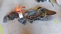 Orange Vector 1 ton chain block hoist with long heavy chains and a woven fabric lifting sling with metal D-rings.