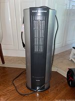 Full front view of the Four Seasons Envion humidifier showing power cord and tall grille vent