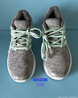 Top view of Adidas Cloudfoam Ortholite women's sneakers in grey and mint green, showing overall condition and lace detail.