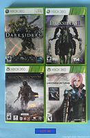 Four Xbox 360 game cases shown closed with cover art for Darksiders, Darksiders II, Shadow of Mordor, and Lightning Returns Final Fantasy XIII.