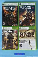 Four Xbox 360 games laid out showing front cover art of Gears of War series and Rage Anarchy Edition.