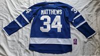 Back view of blue Auston Matthews #34 Toronto Maple Leafs jersey by Reebok, showing name and number.