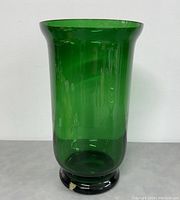 Front view showing the flared rim and clear emerald green color of the vase