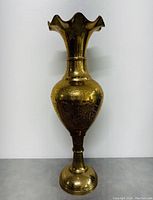 Front view of 24 inch tall etched brass vase with fluted rim showing detailed etching and overall shape.