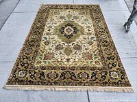 Full view of rug laid flat on concrete showing overall pattern and condition