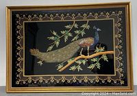 Full view of the large embroidered peacock wall art in gold frame against a white background.