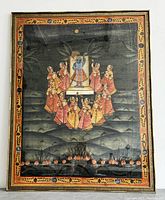 Front view of the large framed Indian painting on silk showing entire artwork and frame with intricate design of deity, women, and landscape.