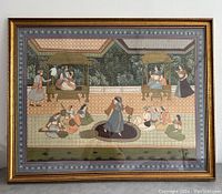 Front view of the large framed Indian painting on silk depicting a traditional musical and dance scene with multiple figures, detailed patterns, and a gold-toned ornate frame.