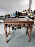 Front view of wooden Chinese desk showing carved apron and leg structure