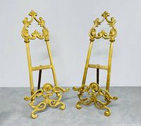 Two brass plate stands side by side, showing full front view and detailing