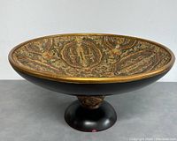Side angle view of the large vintage footed fruit bowl showcasing the black pedestal base and intricate interior pattern.